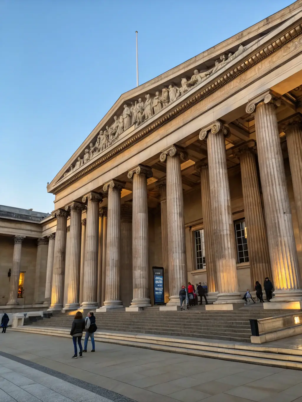 A photograph of the museum's entrance, showcasing its historical architecture and welcoming atmosphere, with visitors entering to explore the exhibits.